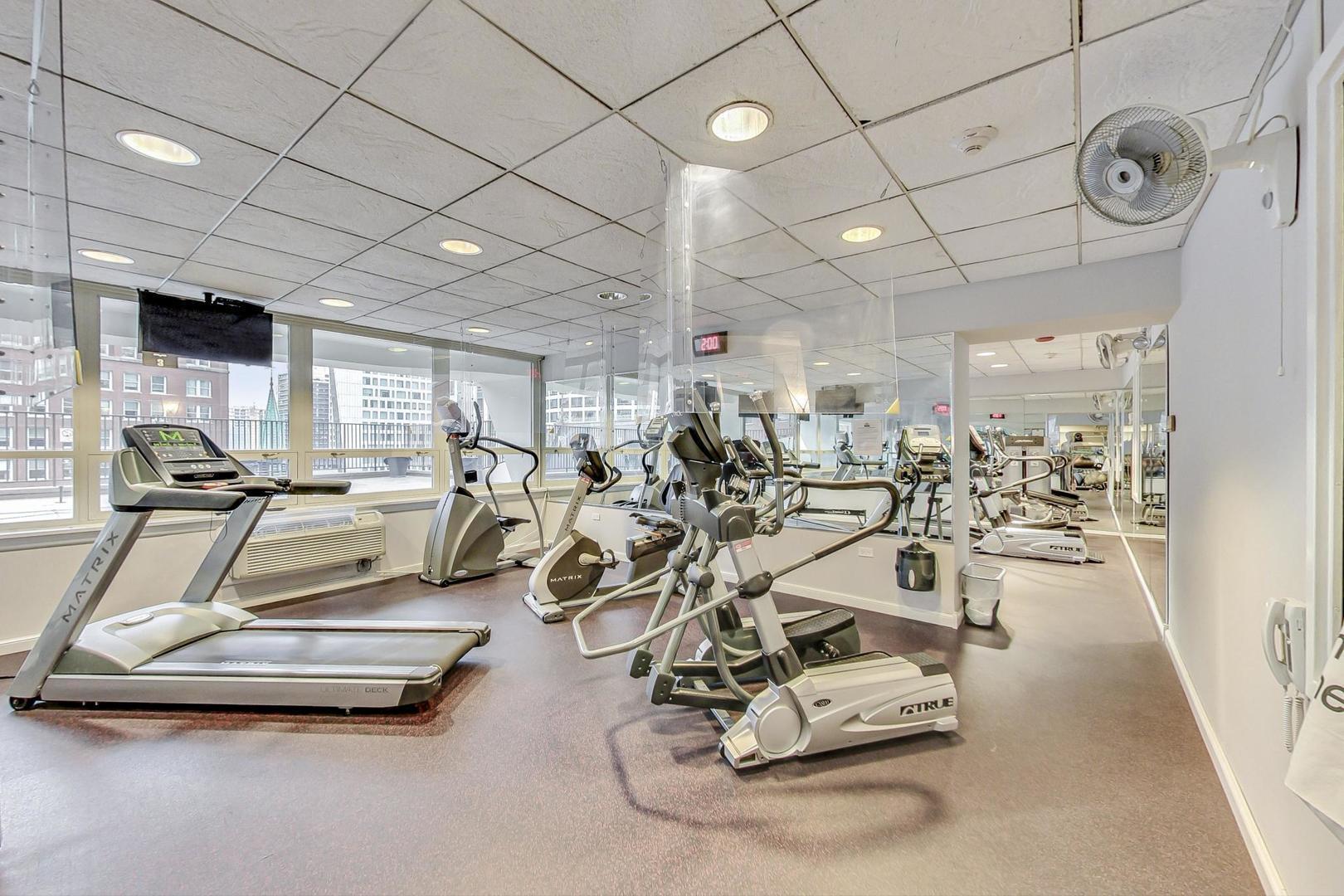 111 East Chestnut Street, Unit 38C Chicago, IL 60611 - Photo 36 of 39 a room with gym equipment and a view of living room