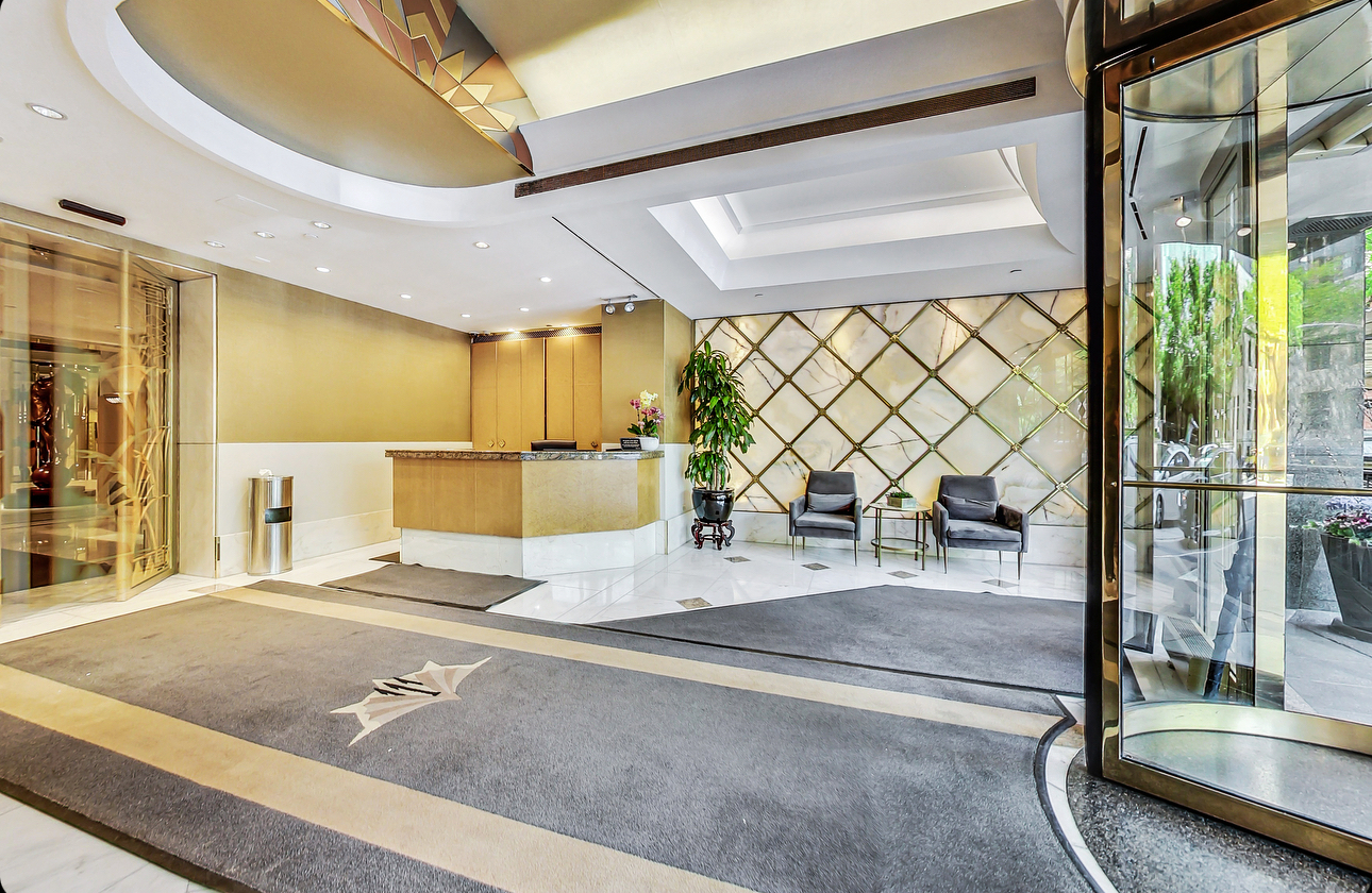 111 East Chestnut Street, Unit 38C Chicago, IL 60611 - Photo 39 of 39 a view of a hall with a couch and wooden floor