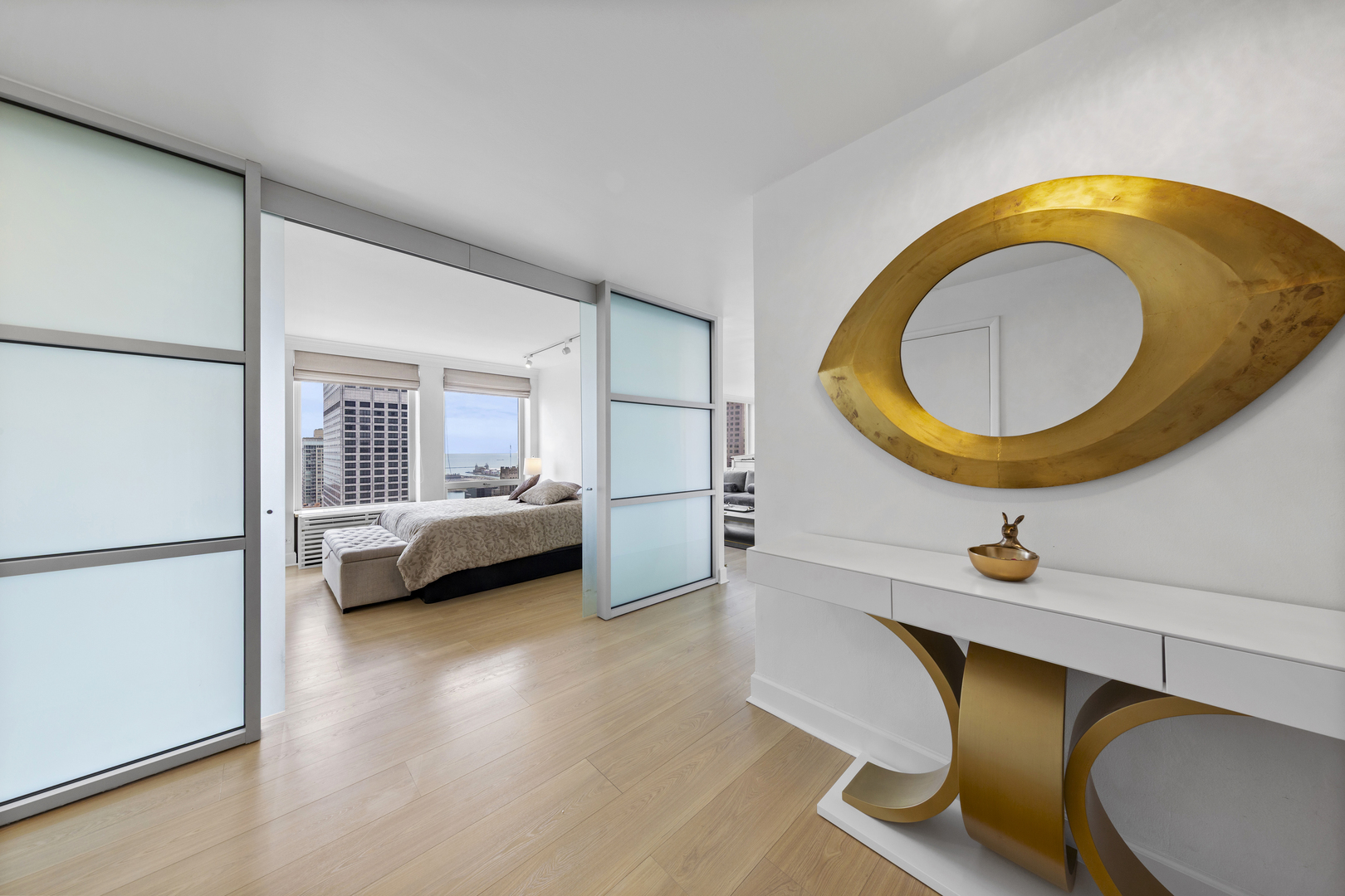 111 East Chestnut Street, Unit 38C Chicago, IL 60611 - Photo 4 of 39 a bedroom with a bed and a wooden floor