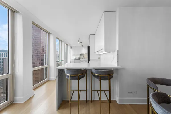 a kitchen with white cabinets and white appliances
