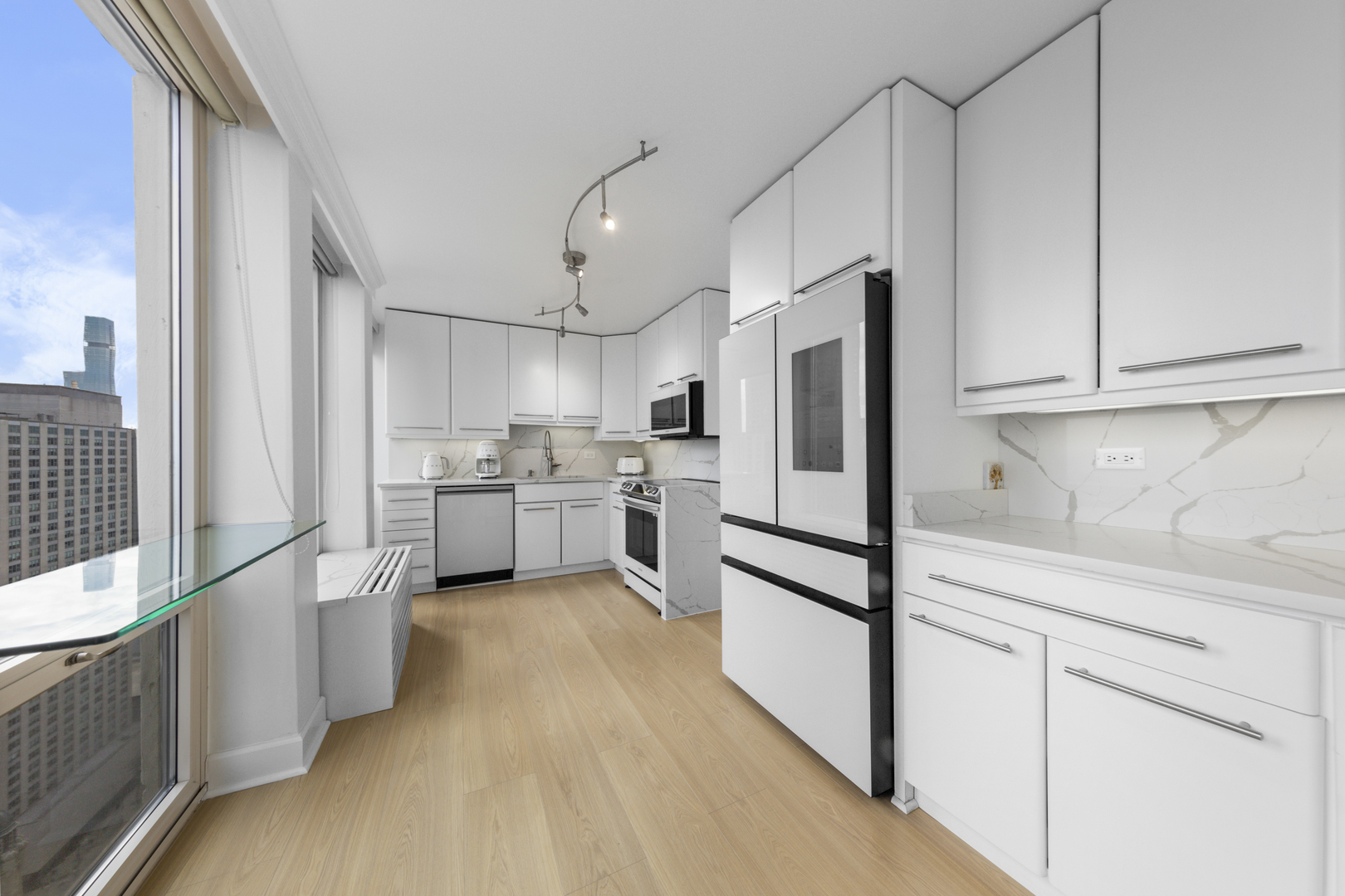 111 East Chestnut Street, Unit 38C Chicago, IL 60611 - Photo 6 of 39 a kitchen with white cabinets and white appliances