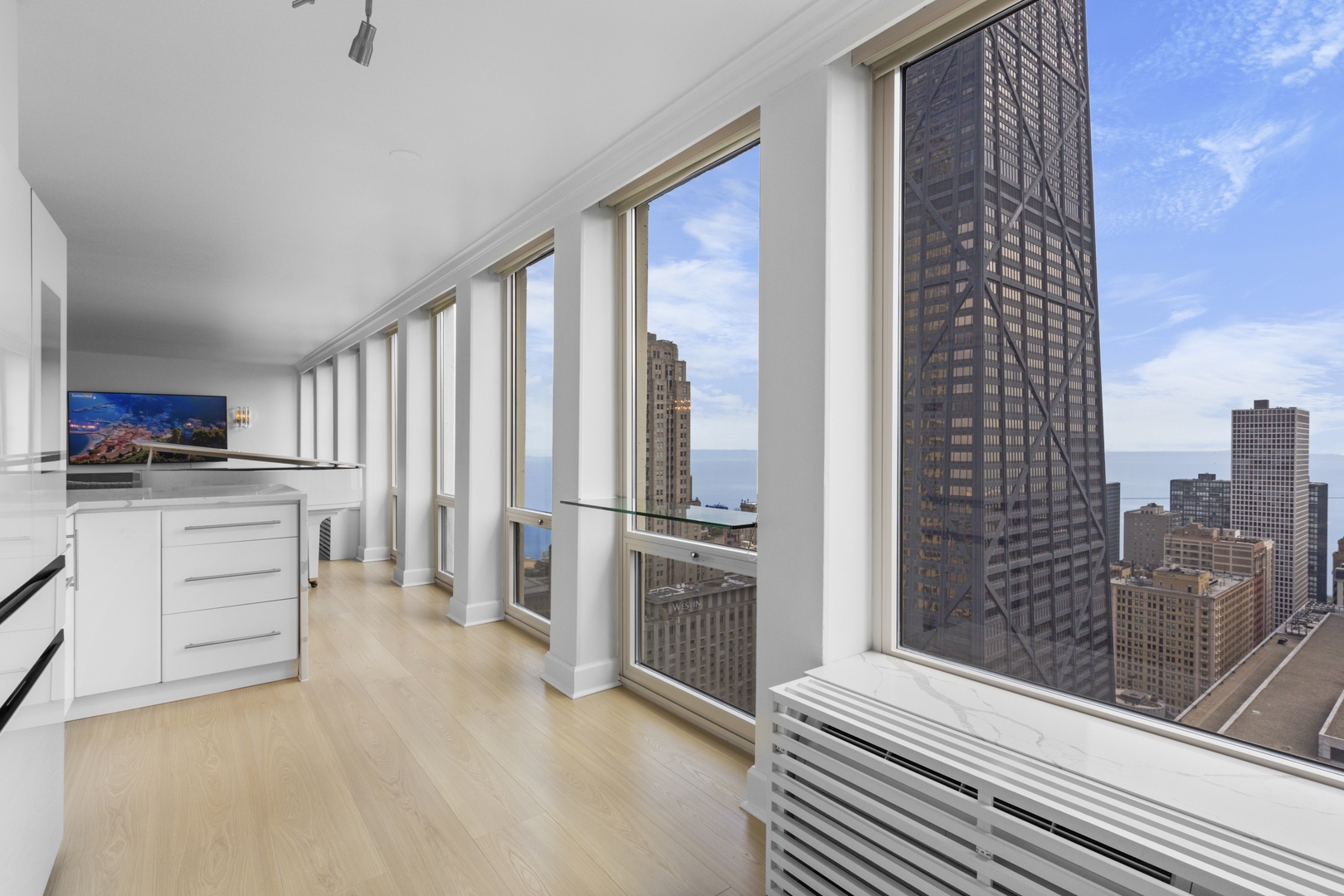 111 East Chestnut Street, Unit 38C Chicago, IL 60611 - Photo 8 of 39 a kitchen with a refrigerator and white cabinets