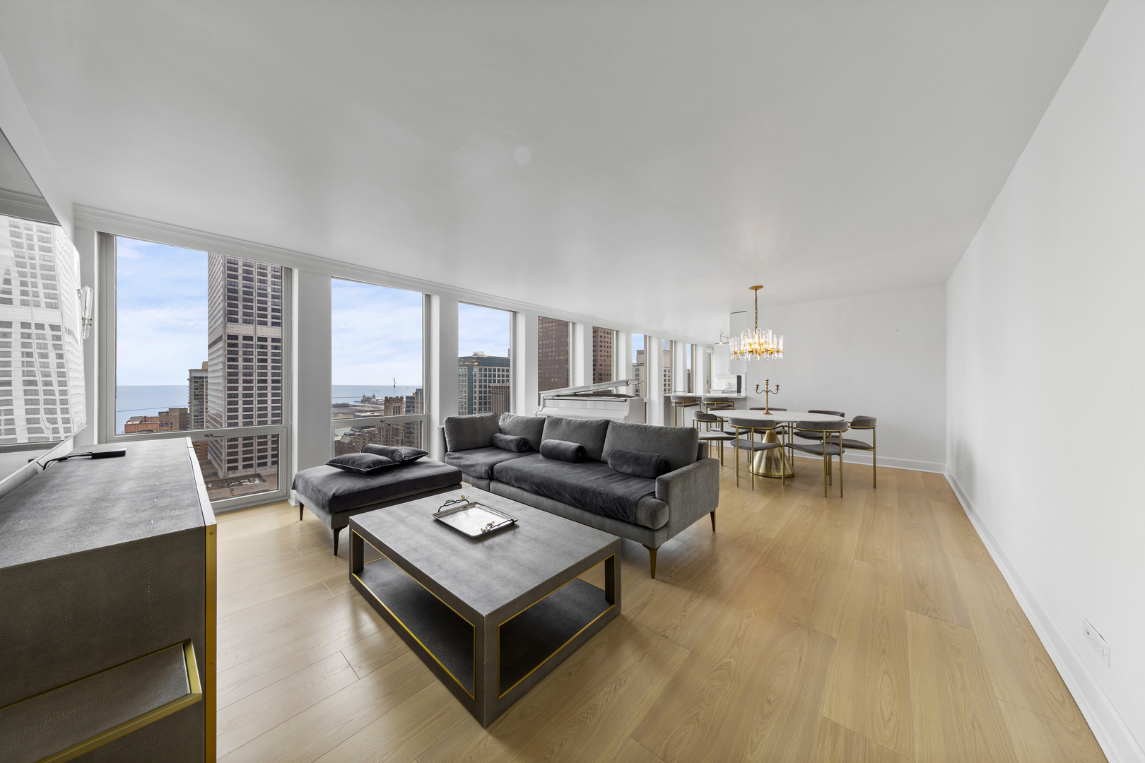 111 East Chestnut Street, Unit 38C Chicago, IL 60611 - Photo 10 of 39 a living room with furniture and a table