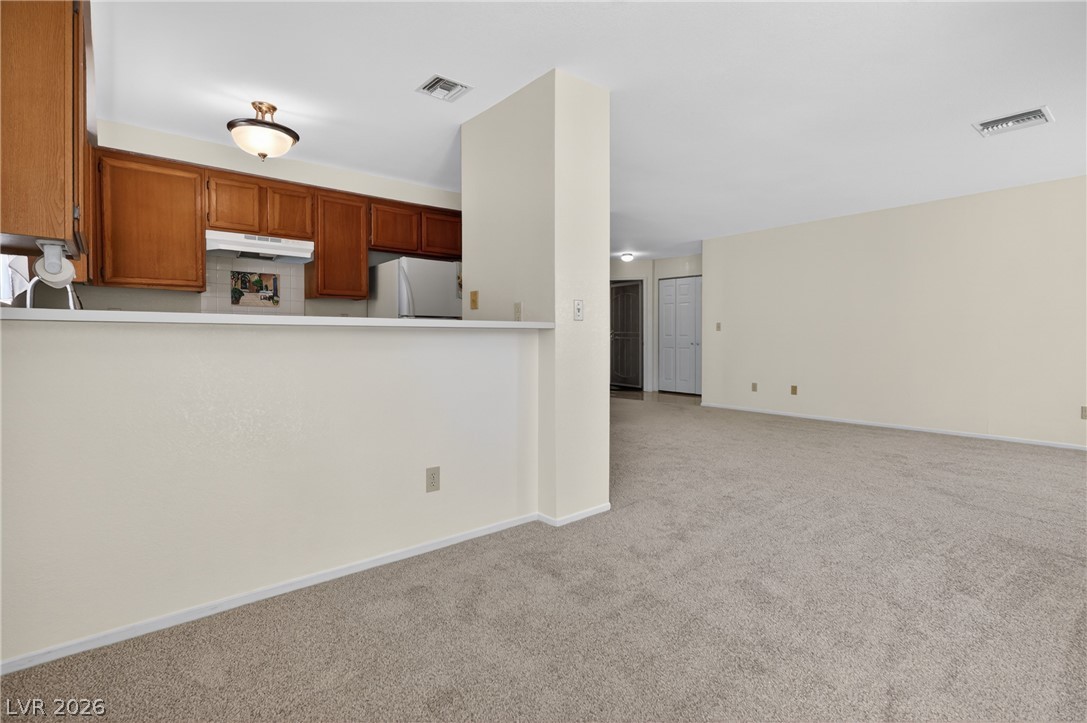 2241 Highpointe Drive, Unit 101 Laughlin, NV 89029 - Photo 8 of 23 This inviting space combines a functional kitchen with an expansive living area, perfect for daily living.