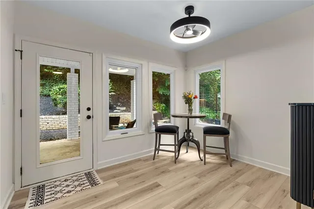a view of a livingroom with furniture wooden floor and windows
