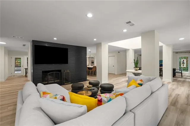 a living room with furniture fireplace and a flat screen tv