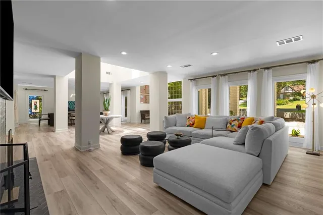 a living room with furniture and wooden floor