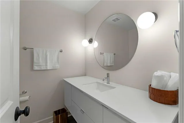 a bathroom with a sink vanity and a mirror