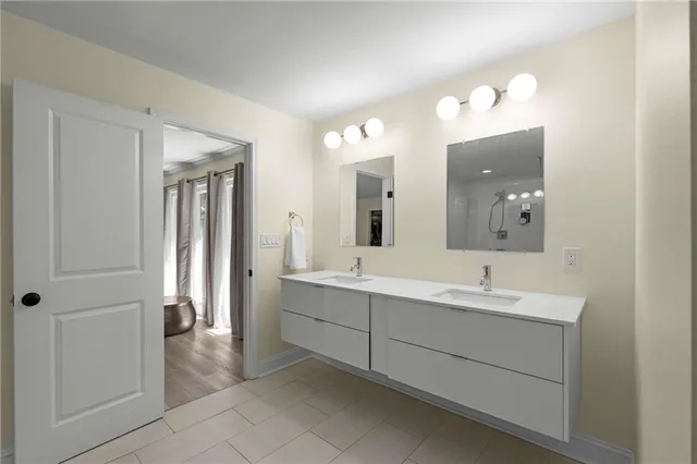 a spacious bathroom with a double vanity sink mirror and