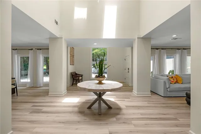 a living room with furniture and a dining table