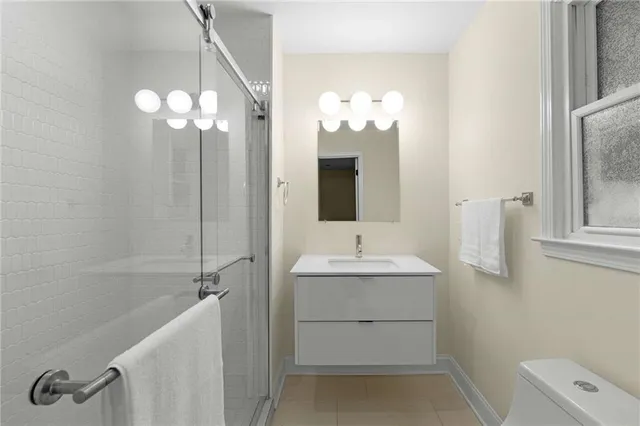 a bathroom with a double vanity sink mirror and shower