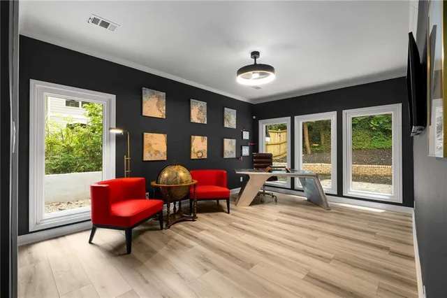 a living room with furniture a air conditioner and large windows