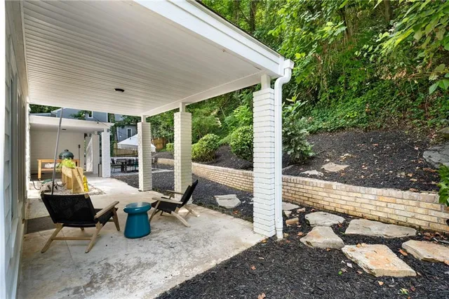 a view of a patio with table and chairs and wooden floor