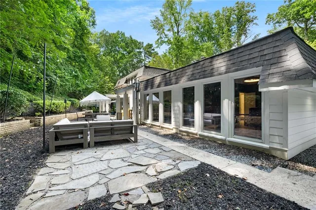 a backyard of a house with barbeque oven and outdoor seating