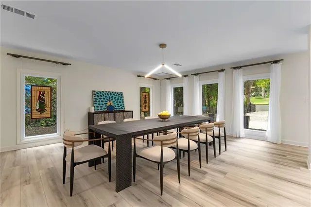 a view of a dining room with furniture window and wooden floor