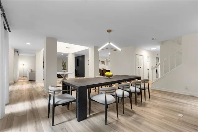 a dining room with furniture and wooden floor