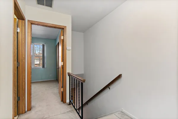 a view of a hallway with a white walls