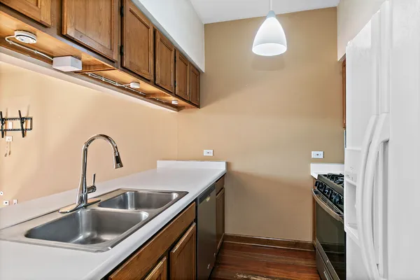 a kitchen with a sink and a refrigerator