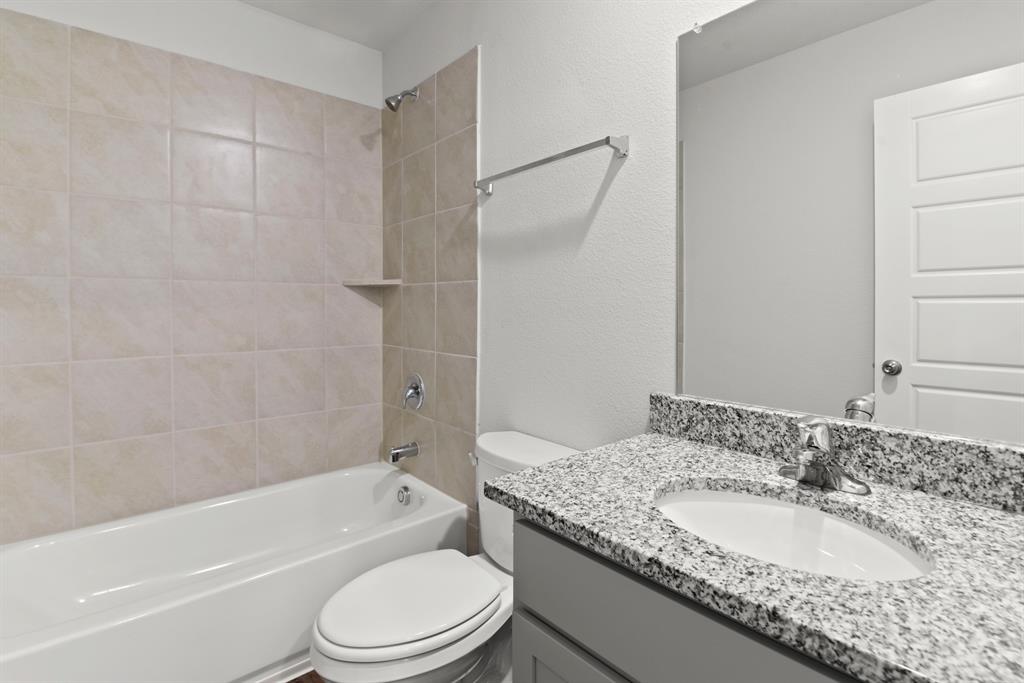 5024 Cervinae Road Crowley, TX 76036 - Photo 13 of 38 a bathroom with a granite countertop toilet sink and shower