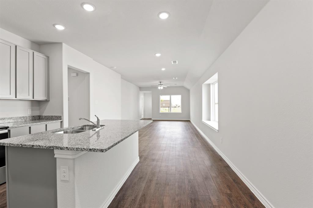 5024 Cervinae Road Crowley, TX 76036 - Photo 4 of 38 a kitchen with granite countertop sink stove and cabinets