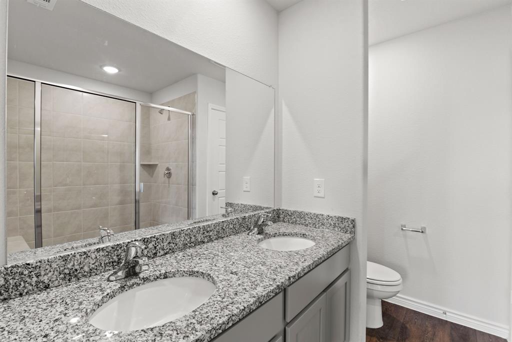 5024 Cervinae Road Crowley, TX 76036 - Photo 10 of 38 a bathroom with a granite countertop sink a toilet and shower