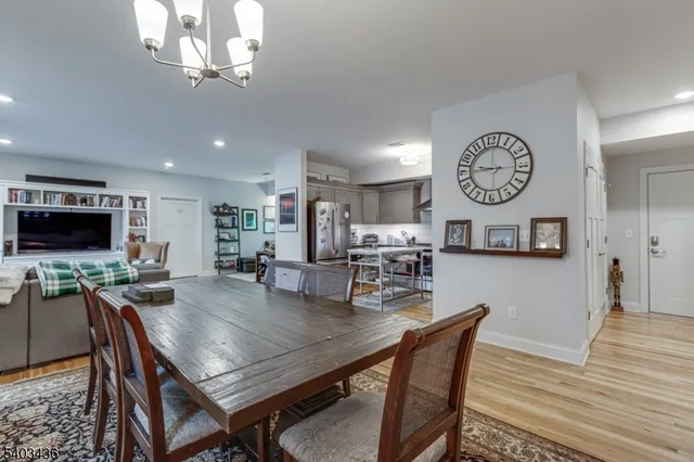 a view of a dining room with furniture a rug and wooden floor
