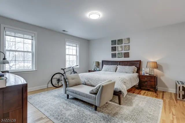 a spacious bedroom with bed and a window