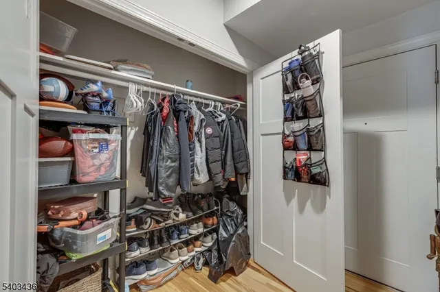 a view of walk in closet with clothes and shoes