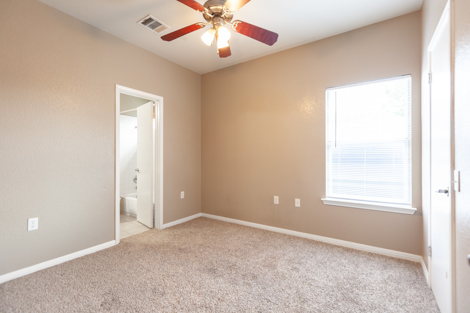 2326 Webberville Road, Unit B Austin, TX 78702 - Photo 12 of 15 Carpeted room featuring a ceiling fan with light fixture, neutral wall paint, and white trim