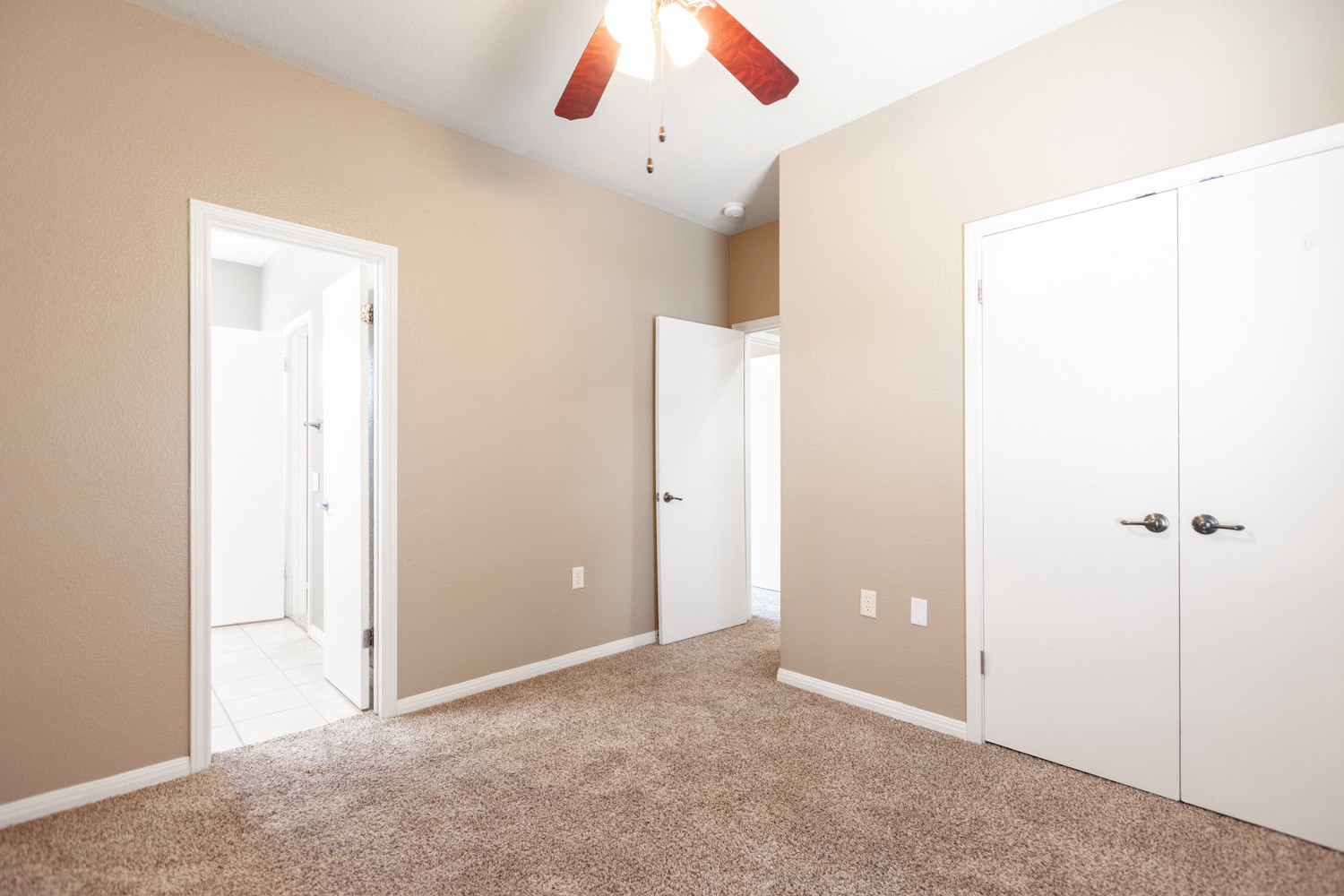 2326 Webberville Road, Unit B Austin, TX 78702 - Photo 15 of 15 Carpeted room featuring neutral wall tones, a ceiling fan with light fixture, and white trim