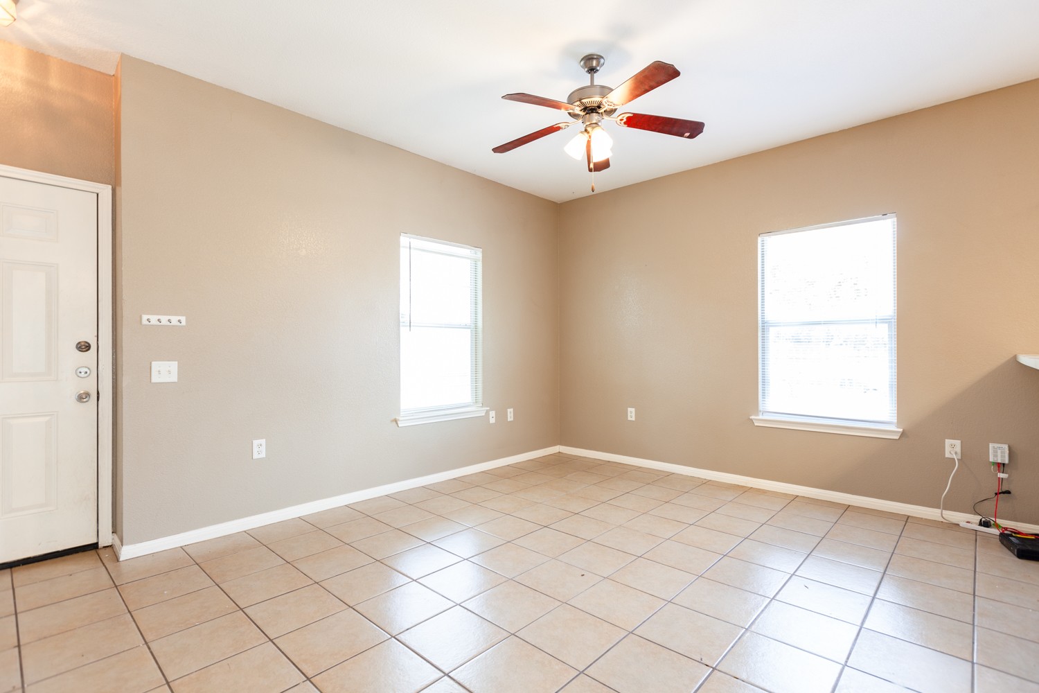 2326 Webberville Road, Unit B Austin, TX 78702 - Photo 4 of 15 Spacious room featuring tile flooring, neutral wall tones, and white trim