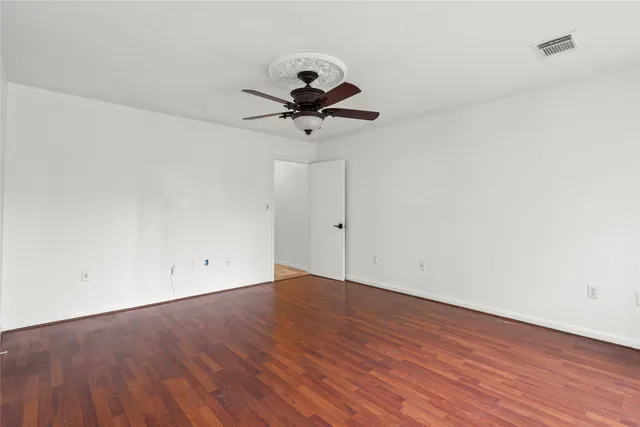 a view of an empty room and wooden floor