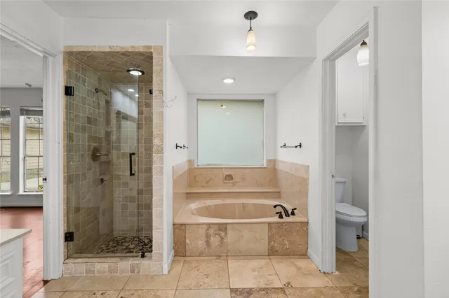 a bathroom with a tub shower and sink