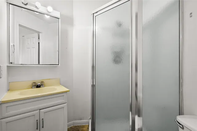 a bathroom with a sink and mirror with toilet