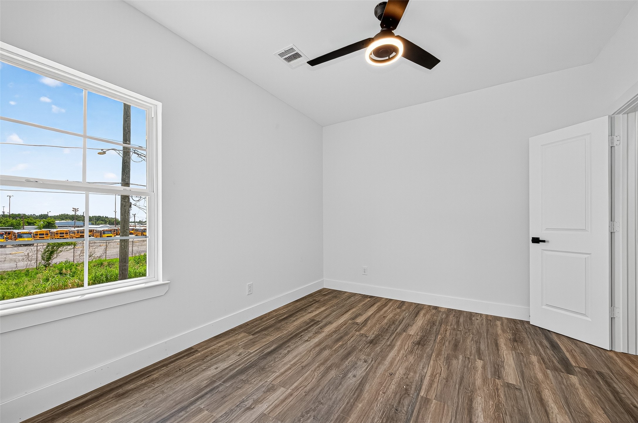 3168 Golfcrest Houston, TX 77087 - Photo 13 of 14 a view of a room with wooden floor cabinet and windows