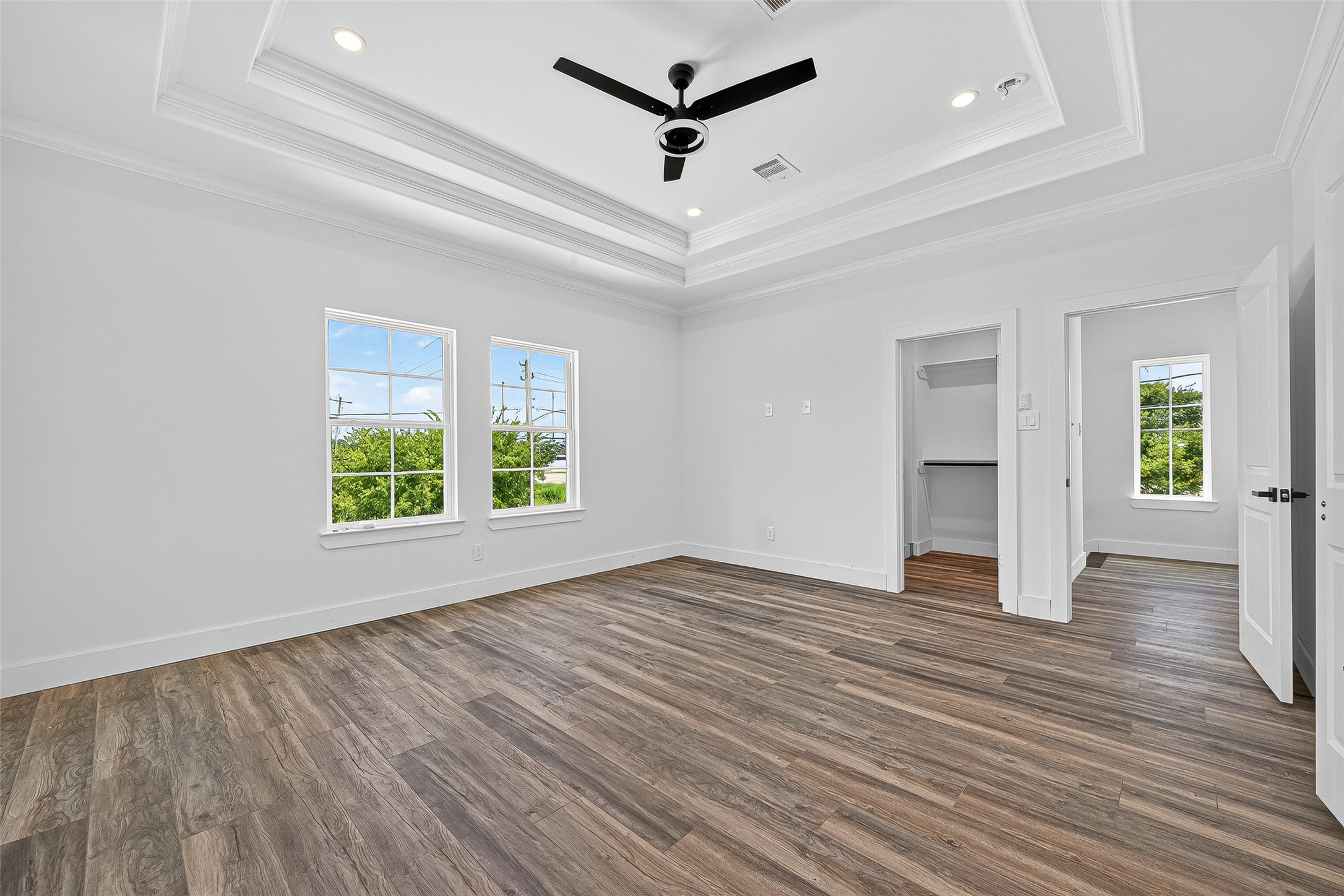 3168 Golfcrest Houston, TX 77087 - Photo 7 of 14 an empty room with wooden floor ceiling fan and windows