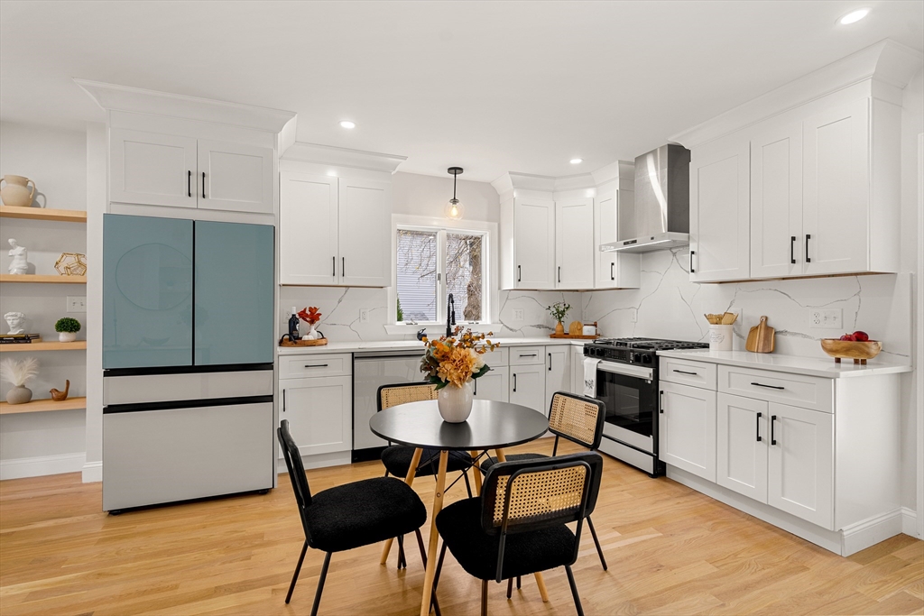 7 Davis Street Saugus, MA 01906 - Photo 14 of 42 a kitchen with stainless steel appliances kitchen island granite countertop a dining table and chairs