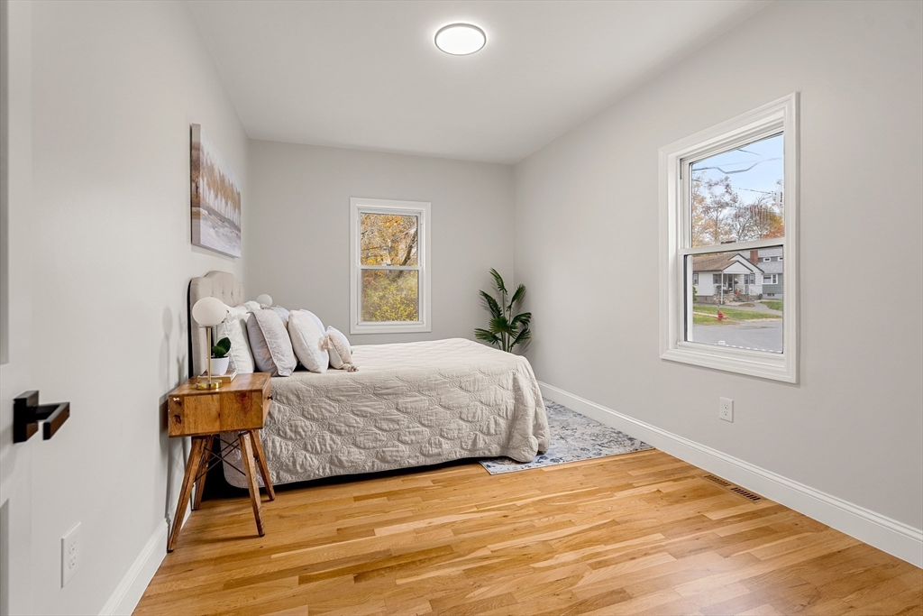 7 Davis Street Saugus, MA 01906 - Photo 18 of 42 a bedroom with a bed and painting on the wall