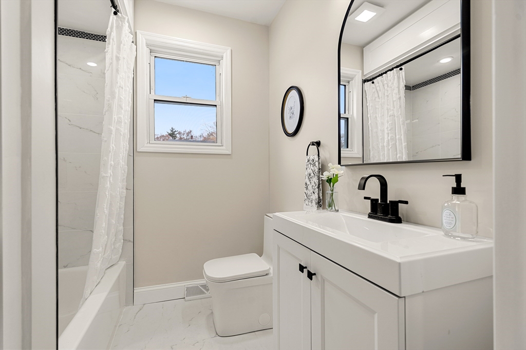 7 Davis Street Saugus, MA 01906 - Photo 21 of 42 a bathroom with a sink toilet and mirror
