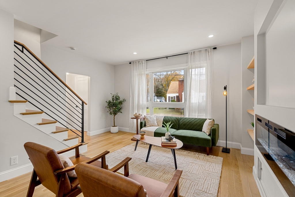 7 Davis Street Saugus, MA 01906 - Photo 9 of 42 a living room with furniture and a fireplace