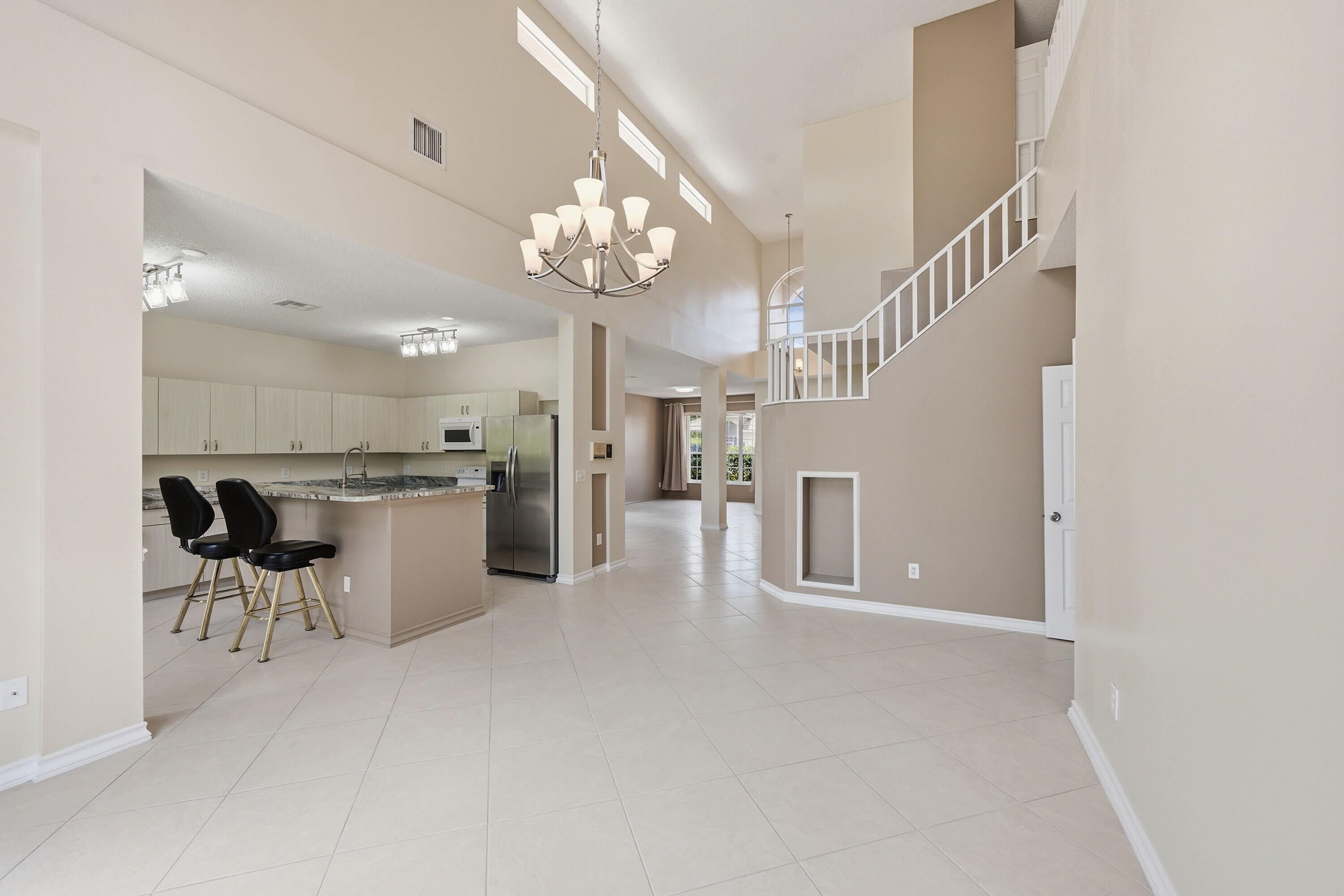 18474 Old Princeton Lane Boca Raton, FL 33498 - Photo 14 of 46 a view of a dining room with furniture a chandelier and wooden floor