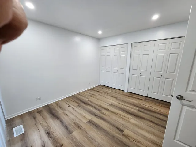 a view of room with wooden floor