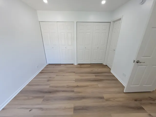 a view of a room with wooden floor