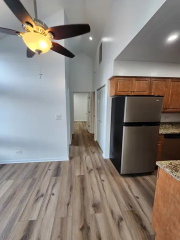a view of empty room with wooden floor