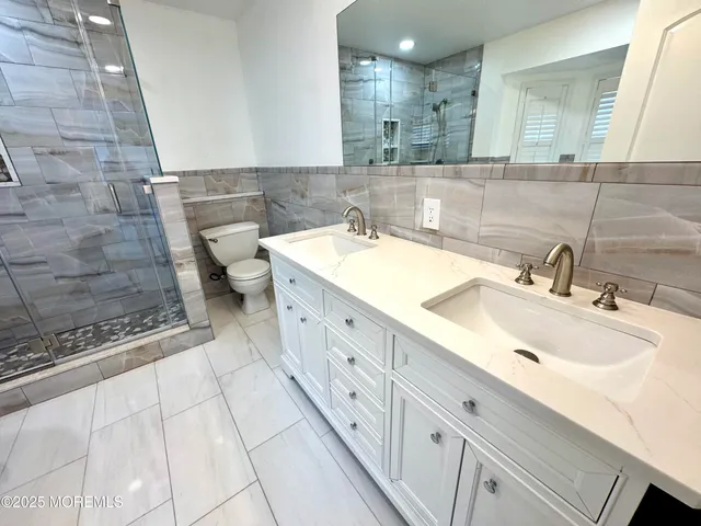 a spacious bathroom with a double vanity sink mirror and double
