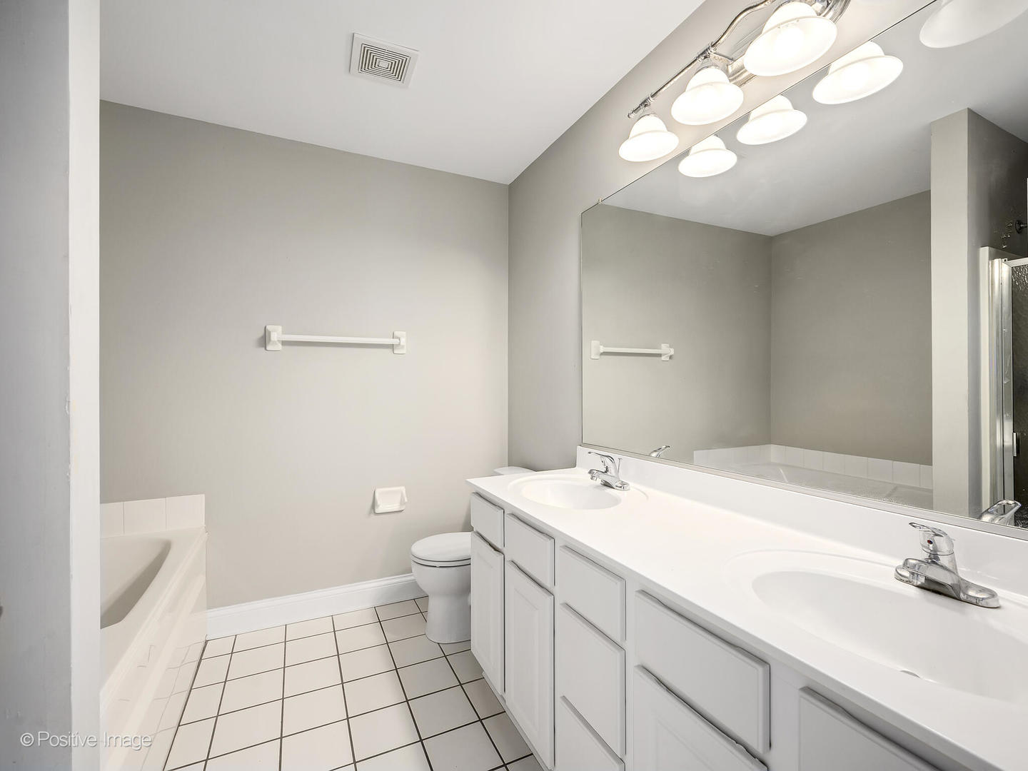 11 Foxcroft Road, Unit 115 Naperville, IL 60565 - Photo 11 of 17 a bathroom with a sink a toilet and a mirror