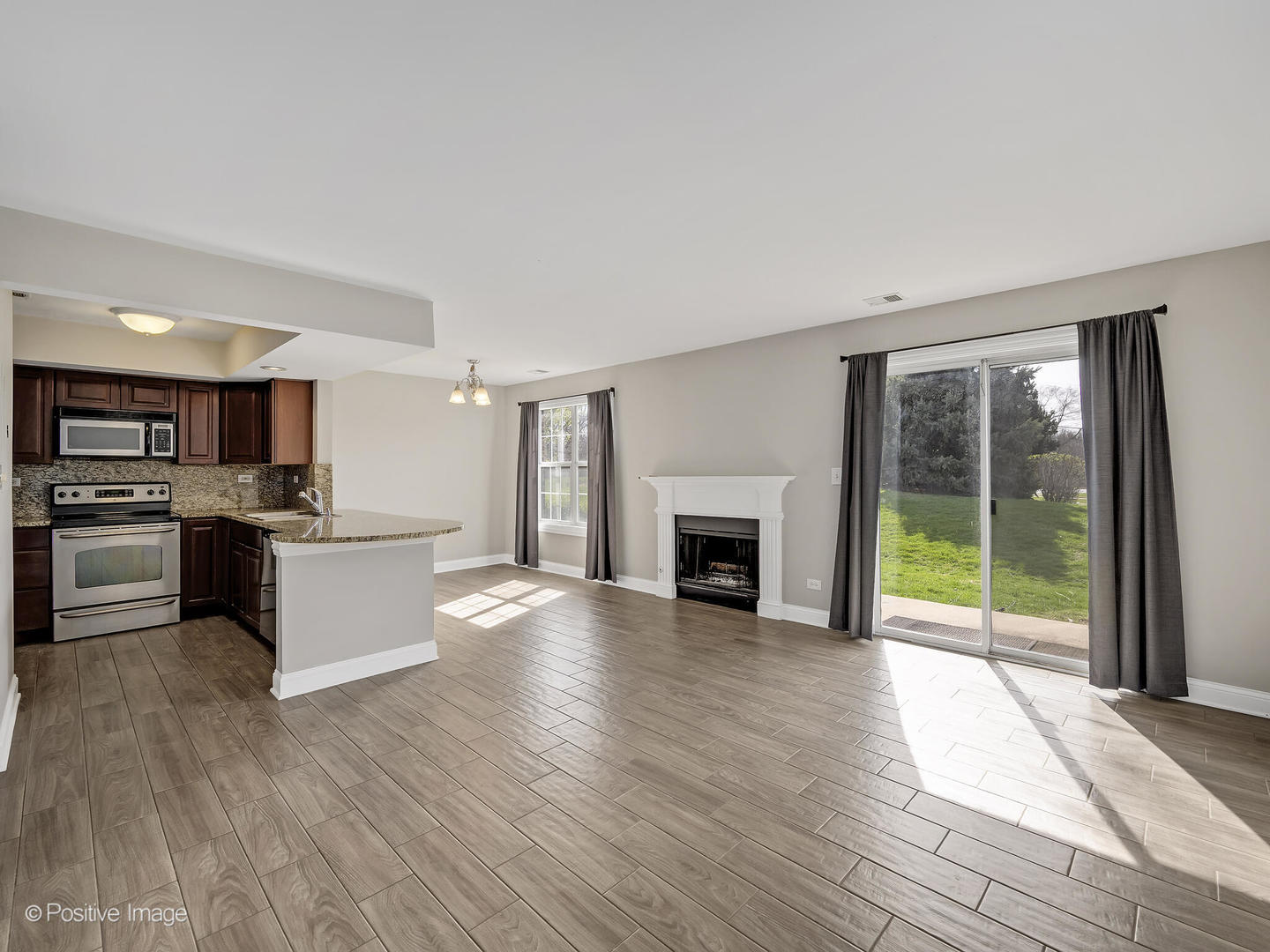 11 Foxcroft Road, Unit 115 Naperville, IL 60565 - Photo 2 of 17 a view of kitchen with cabinets and wooden floor