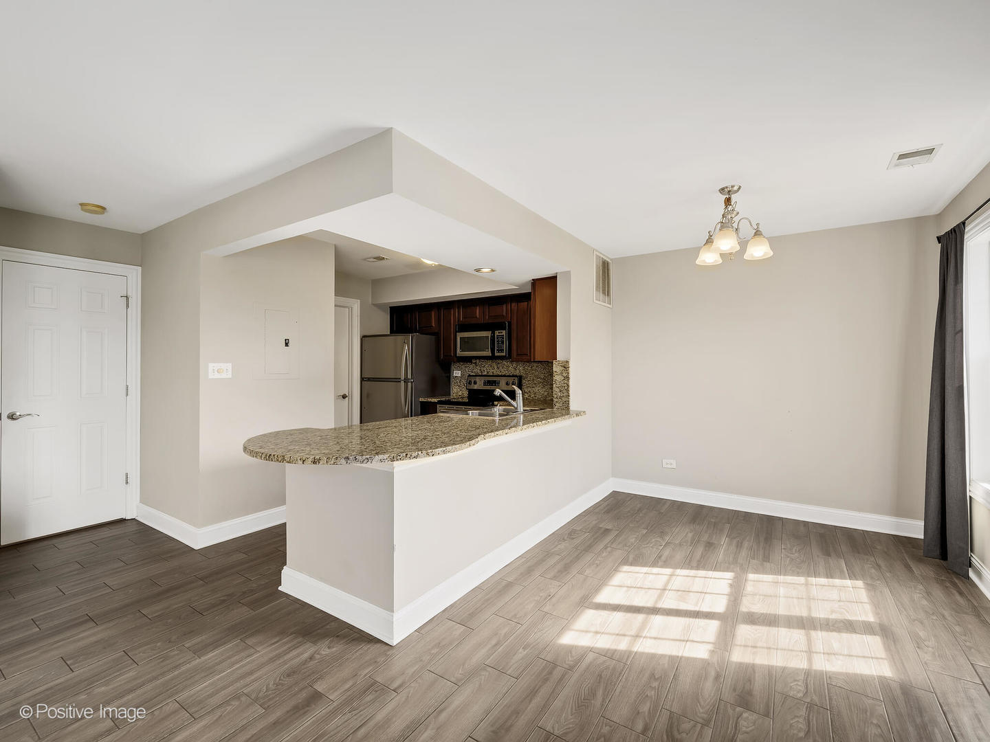 11 Foxcroft Road, Unit 115 Naperville, IL 60565 - Photo 3 of 17 a living room with stainless steel appliances kitchen island hardwood floor and window