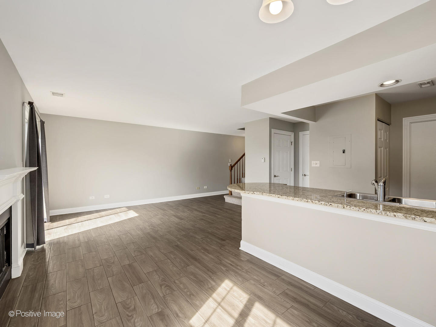 11 Foxcroft Road, Unit 115 Naperville, IL 60565 - Photo 5 of 17 a view of a kitchen with a sink and a large mirror