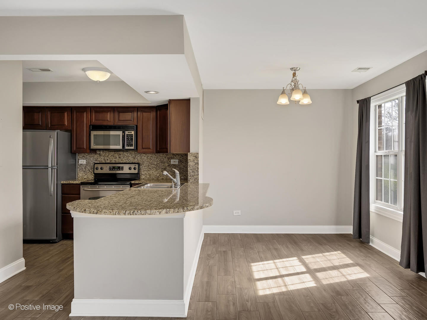 11 Foxcroft Road, Unit 115 Naperville, IL 60565 - Photo 6 of 17 a kitchen with stainless steel appliances granite countertop a refrigerator a stove a sink and a microwave
